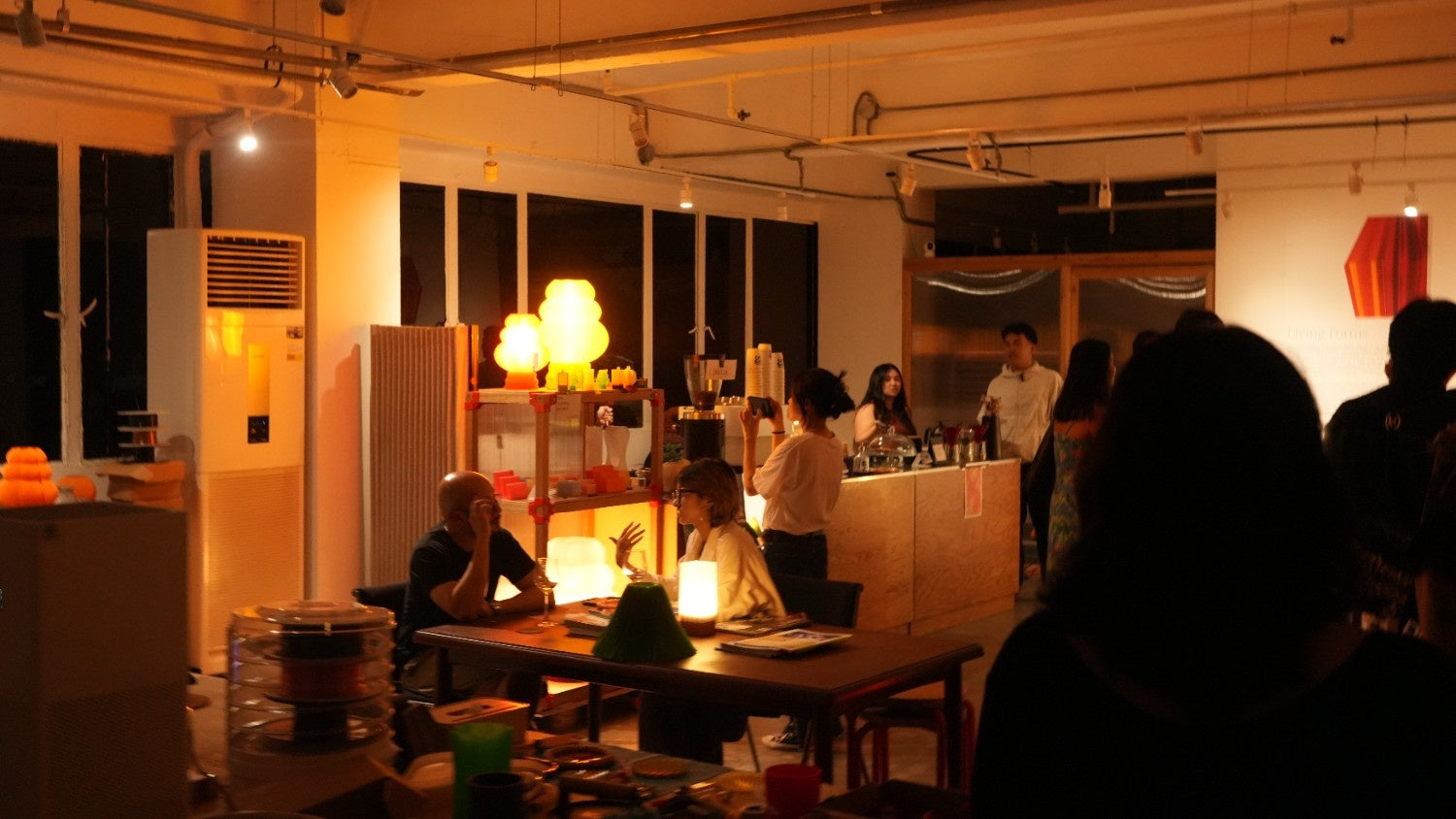 People working in a design studio with warm ambient lighting